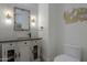 Elegant powder room features hexagon tile, granite vanity, and decorative art at 922 E Desert Hills Estate Dr, Phoenix, AZ 85086