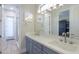 Elegant bathroom with dual vanities, a large mirror, and modern fixtures at 922 E Desert Hills Estate Dr, Phoenix, AZ 85086