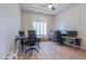 Spacious home office featuring a large desk and hardwood floors at 922 E Desert Hills Estate Dr, Phoenix, AZ 85086