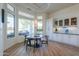 Bright eat-in kitchen with white cabinets, granite counters, and view to backyard at 922 E Desert Hills Estate Dr, Phoenix, AZ 85086