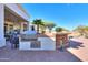 Outdoor kitchen with built-in grill, bar seating, and ample countertop space at 922 E Desert Hills Estate Dr, Phoenix, AZ 85086