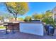 Built-in outdoor kitchen with grill and bar seating at 922 E Desert Hills Estate Dr, Phoenix, AZ 85086