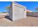 Detached storage shed with single door and light fixture at 922 E Desert Hills Estate Dr, Phoenix, AZ 85086