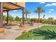 Outdoor oasis with a putting green, pool, and patio at 9255 W Buckskin Trl, Peoria, AZ 85383