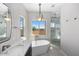 Spa-like bathroom with soaking tub, walk-in shower, and herringbone tile at 9255 W Buckskin Trl, Peoria, AZ 85383