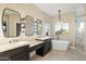 Spa-like bathroom with double vanity, large soaking tub, and walk-in shower at 9255 W Buckskin Trl, Peoria, AZ 85383