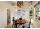 Small dining area with wooden table and four chairs, near a bathroom at 9255 W Buckskin Trl, Peoria, AZ 85383