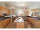 Spacious kitchen with island, stainless steel appliances, and wood cabinets at 9255 W Buckskin Trl, Peoria, AZ 85383