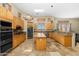 Large kitchen with an island, stainless steel appliances, and wood cabinets at 9255 W Buckskin Trl, Peoria, AZ 85383