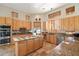 Kitchen features island, stainless steel appliances, and wood cabinets at 9255 W Buckskin Trl, Peoria, AZ 85383