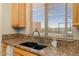 Kitchen sink with granite countertop and a view of the backyard at 9255 W Buckskin Trl, Peoria, AZ 85383