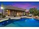 Relaxing pool and hot tub with string lights at sunset at 9255 W Buckskin Trl, Peoria, AZ 85383