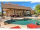 Inviting pool area with patio furniture and string lights at 9255 W Buckskin Trl, Peoria, AZ 85383