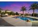 Inviting pool and jacuzzi with a waterfall feature at sunset at 9255 W Buckskin Trl, Peoria, AZ 85383