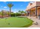 Landscaped backyard featuring a putting green at 9255 W Buckskin Trl, Peoria, AZ 85383