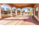 Spacious covered patio with columns and a stone bench, overlooking a manicured yard at 928 E Valencia Dr, Phoenix, AZ 85042