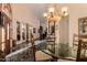 Formal dining area with a glass-top table and marble floors at 928 E Valencia Dr, Phoenix, AZ 85042