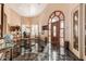 Bright entryway with a dark marble floor, featuring a dining area and access to other rooms at 928 E Valencia Dr, Phoenix, AZ 85042