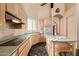 Eat-in kitchen with corner sink, wood cabinets and recessed lighting at 928 E Valencia Dr, Phoenix, AZ 85042