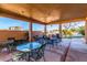 Covered patio with outdoor seating and built-in grill at 928 E Valencia Dr, Phoenix, AZ 85042