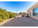 Gravel side yard with gate access and mature shrubs at 928 E Valencia Dr, Phoenix, AZ 85042