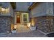 Inviting entryway with stone accents, a charming sitting area, and well-placed lighting at 9343 W Cashman Dr, Peoria, AZ 85383