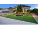 Landscaped front yard with artificial turf and a welcoming walkway to the entrance of the home at 9343 W Cashman Dr, Peoria, AZ 85383