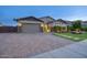 Curb appeal abounds in this inviting home showcasing a large driveway and meticulous landscaping at 9343 W Cashman Dr, Peoria, AZ 85383