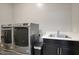 Laundry room with washer, dryer, and utility sink at 9343 W Cashman Dr, Peoria, AZ 85383