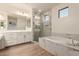 Elegant bathroom with a soaking tub, walk-in shower, and double vanity at 9430 W Jj Ranch Rd, Peoria, AZ 85383