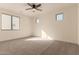 Well-lit bedroom featuring a ceiling fan and large window at 9430 W Jj Ranch Rd, Peoria, AZ 85383