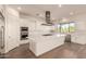 Modern kitchen with white cabinets, quartz countertops, and stainless steel appliances at 9430 W Jj Ranch Rd, Peoria, AZ 85383