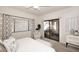 Comfortable bedroom with a queen bed and access to a balcony at 9455 E Raintree Dr # 2049, Scottsdale, AZ 85260