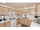 Well-equipped kitchen with light wood cabinets and white appliances at 9455 E Raintree Dr # 2049, Scottsdale, AZ 85260