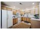 Bright kitchen with light wood cabinets and white appliances at 9455 E Raintree Dr # 2049, Scottsdale, AZ 85260