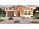 Tan single story home with brown garage door and desert landscaping at 9494 W Raven Dr, Arizona City, AZ 85123