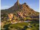 Aerial view of a golf course with dramatic rock formations at 10040 E Happy Valley Rd # 1041, Scottsdale, AZ 85255