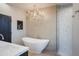 Spa-like bathroom featuring a freestanding bathtub and a chandelier at 10040 E Happy Valley Rd # 1041, Scottsdale, AZ 85255