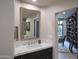 Bathroom with a vanity, large mirror, and access to library at 10040 E Happy Valley Rd # 1041, Scottsdale, AZ 85255