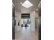 Light-filled entryway with high ceilings, hardwood floors, and views into the living area at 10040 E Happy Valley Rd # 1041, Scottsdale, AZ 85255