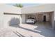 Spacious garage with car, storage cabinets, and epoxy flooring at 10040 E Happy Valley Rd # 1041, Scottsdale, AZ 85255