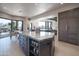 Spacious kitchen with breakfast bar, granite island, and access to patio at 10040 E Happy Valley Rd # 1041, Scottsdale, AZ 85255