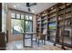 Bright home office with large window, built-in shelves, and a desk at 10040 E Happy Valley Rd # 1041, Scottsdale, AZ 85255