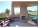 Outdoor patio with fireplace, seating area, and mountain views at 10040 E Happy Valley Rd # 1041, Scottsdale, AZ 85255