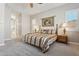 Main bedroom with plush carpeting, ensuite bathroom access, and a ceiling fan at 10062 W Redbird Rd, Peoria, AZ 85383