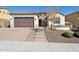 Single-story home with brown garage door and landscaped yard at 10062 W Redbird Rd, Peoria, AZ 85383