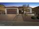 Charming two-story home with a stone facade, landscaped yard, and two-car garage at 10062 W Redbird Rd, Peoria, AZ 85383