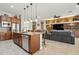 Open kitchen features a large island, breakfast bar, and Gathering room access at 10062 W Redbird Rd, Peoria, AZ 85383