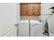 Laundry room with washer, dryer, cabinets, and vacuum at 10062 W Redbird Rd, Peoria, AZ 85383
