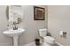 Stylish powder room with pedestal sink and toilet at 10062 W Redbird Rd, Peoria, AZ 85383